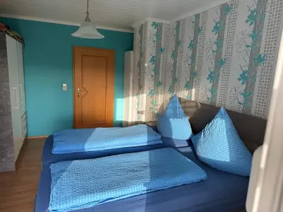 Ein Bett oder Betten in einem Zimmer der Unterkunft Ferienwohnung Hochwaldblick 1