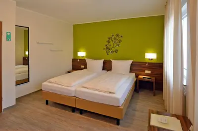Ein Bett oder Betten in einem Zimmer der Unterkunft L' Angolo Ristorante & Hotel GmbH