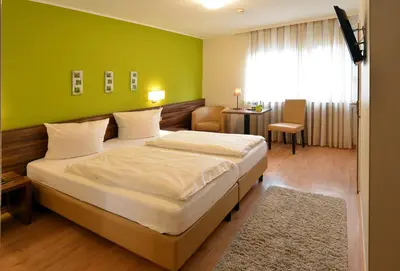 Ein Bett oder Betten in einem Zimmer der Unterkunft L' Angolo Ristorante & Hotel GmbH
