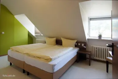 Ein Bett oder Betten in einem Zimmer der Unterkunft L' Angolo Ristorante & Hotel GmbH
