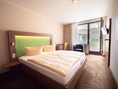 Ein Bett oder Betten in einem Zimmer der Unterkunft Hotel Villa am Rhein