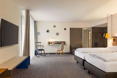 Ein Bett oder Betten in einem Zimmer der Unterkunft Vienna House Easy by Wyndham Trier