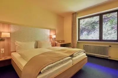 Ein Bett oder Betten in einem Zimmer der Unterkunft Moselromantik Hotel Weissmühle