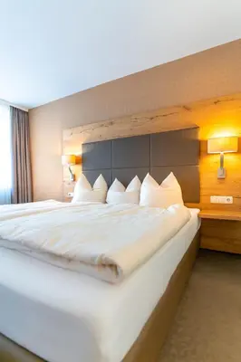 Ein Bett oder Betten in einem Zimmer der Unterkunft Hotel Restaurant Pollmanns