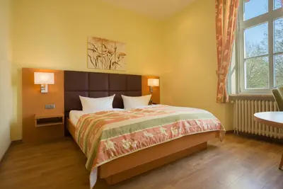 Ein Bett oder Betten in einem Zimmer der Unterkunft Berghotel Kockelsberg