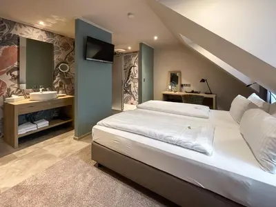 Ein Bett oder Betten in einem Zimmer der Unterkunft Hotel Germania