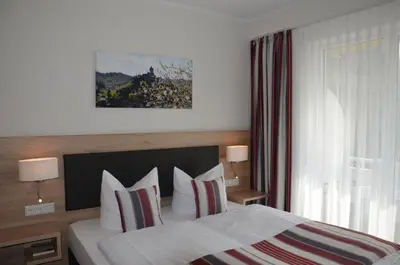 Ein Bett oder Betten in einem Zimmer der Unterkunft Flair Hotel am Rosenhügel - Garni