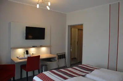 Ein Bett oder Betten in einem Zimmer der Unterkunft Flair Hotel am Rosenhügel - Garni