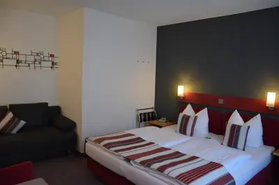 Ein Bett oder Betten in einem Zimmer der Unterkunft Flair Hotel am Rosenhügel - Garni