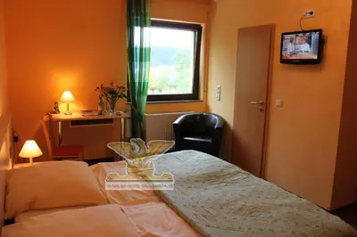 Ein Bett oder Betten in einem Zimmer der Unterkunft Rheinhotel Bellavista