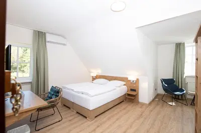 Ein Bett oder Betten in einem Zimmer der Unterkunft Landhotel Kauzenberg