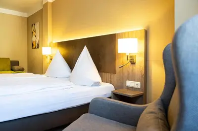 Ein Bett oder Betten in einem Zimmer der Unterkunft Hotel Aulmann