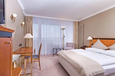 Ein Bett oder Betten in einem Zimmer der Unterkunft Wyndham Garden Lahnstein Koblenz