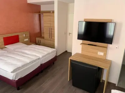 Ein Bett oder Betten in einem Zimmer der Unterkunft Hotel Well Garni