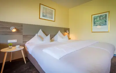 Ein Bett oder Betten in einem Zimmer der Unterkunft Hotel am Park