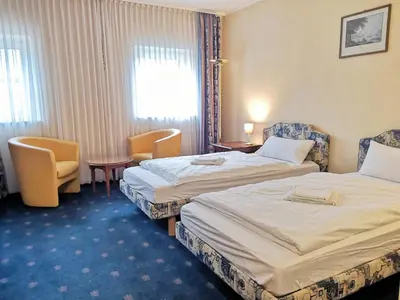 Ein Bett oder Betten in einem Zimmer der Unterkunft LandhotelUllrich