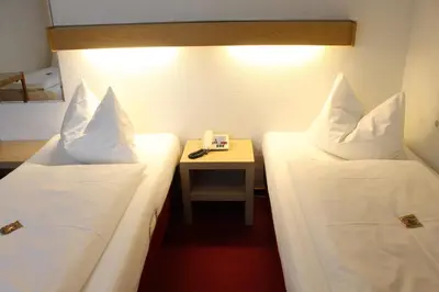 Ein Bett oder Betten in einem Zimmer der Unterkunft Hotel Scholz