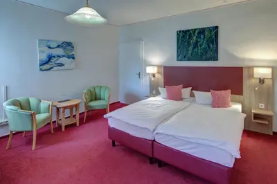 Ein Bett oder Betten in einem Zimmer der Unterkunft Hotel Leander