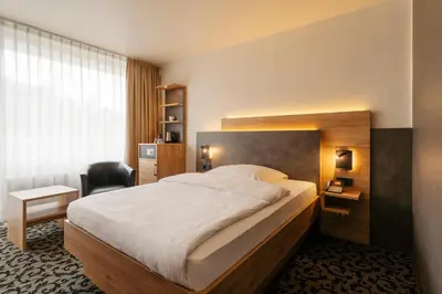 Ein Bett oder Betten in einem Zimmer der Unterkunft Caravelle Hotel im Park