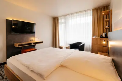 Ein Bett oder Betten in einem Zimmer der Unterkunft Caravelle Hotel im Park