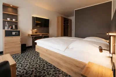 Ein Bett oder Betten in einem Zimmer der Unterkunft Caravelle Hotel im Park
