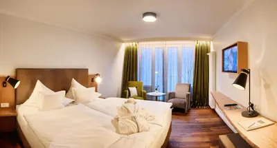 Ein Bett oder Betten in einem Zimmer der Unterkunft Hotel Villa Hügel