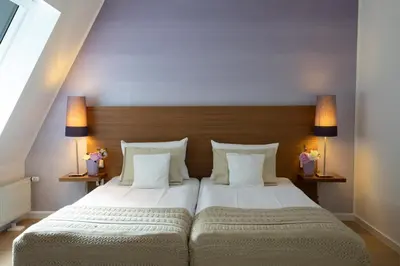 Ein Bett oder Betten in einem Zimmer der Unterkunft Hotel Vulcano Lindenhof