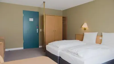 Ein Bett oder Betten in einem Zimmer der Unterkunft Hotel Bitburg