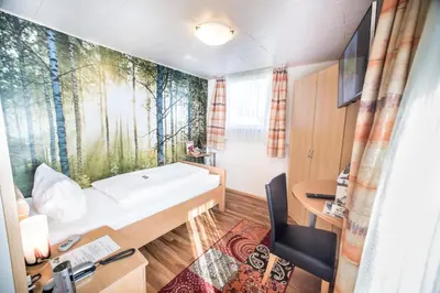 Ein Bett oder Betten in einem Zimmer der Unterkunft Hotel Burgblick