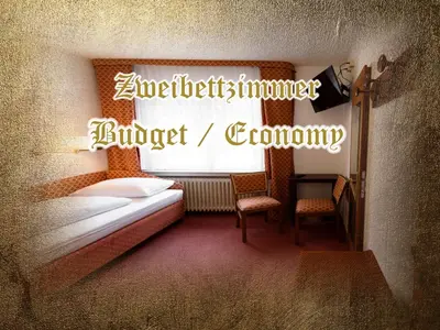 Ein Bett oder Betten in einem Zimmer der Unterkunft Burg-Hotel & Hostel Cochem