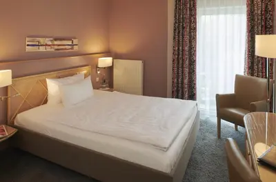Ein Bett oder Betten in einem Zimmer der Unterkunft Parkhotel Weiskirchen