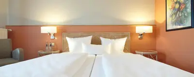 Ein Bett oder Betten in einem Zimmer der Unterkunft Parkhotel Weiskirchen