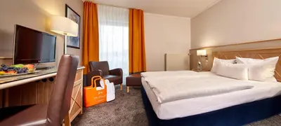 Ein Bett oder Betten in einem Zimmer der Unterkunft Parkhotel Weiskirchen