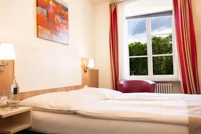 Ein Bett oder Betten in einem Zimmer der Unterkunft Hotel Trierer Hof