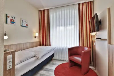 Ein Bett oder Betten in einem Zimmer der Unterkunft Hotel Trierer Hof