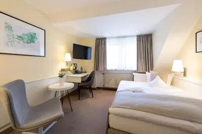 Ein Bett oder Betten in einem Zimmer der Unterkunft Hotel Deutscher Hof