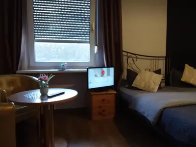 Ein Bett oder Betten in einem Zimmer der Unterkunft Pension Breidbach