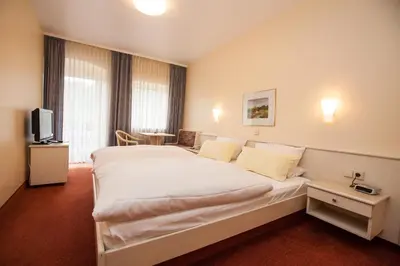 Ein Bett oder Betten in einem Zimmer der Unterkunft Hotel Garni Günther