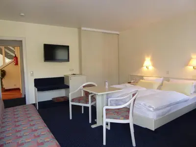 Ein Bett oder Betten in einem Zimmer der Unterkunft Hotel Garni Günther