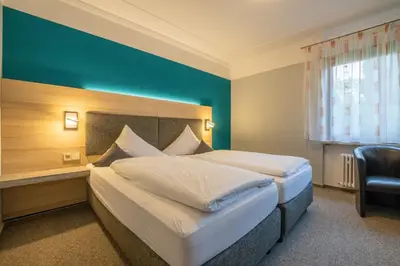 Ein Bett oder Betten in einem Zimmer der Unterkunft BurgStadt-Hotel