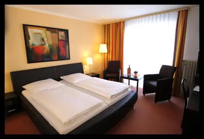 Ein Bett oder Betten in einem Zimmer der Unterkunft Park-Hotel Traben-Trarbach