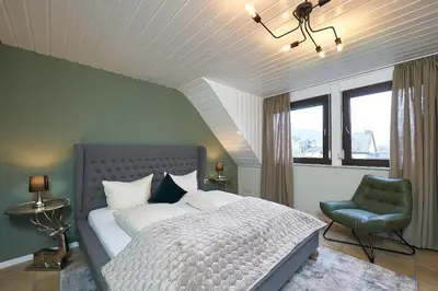 Ein Bett oder Betten in einem Zimmer der Unterkunft Ferienhaus Wehlener Rosengarten