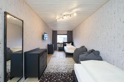 Ein Bett oder Betten in einem Zimmer der Unterkunft Ferienhaus Wehlener Rosengarten