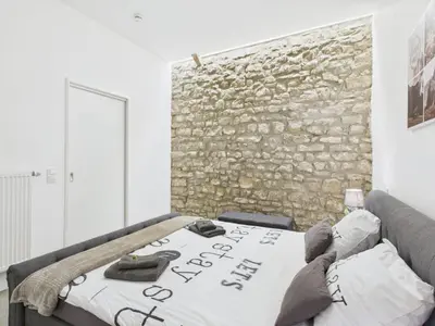 Ein Bett oder Betten in einem Zimmer der Unterkunft Sam's Cottage Suite