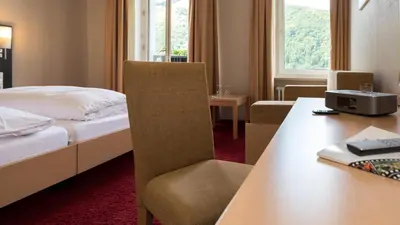 Ein Bett oder Betten in einem Zimmer der Unterkunft Rheinhotel Lamm