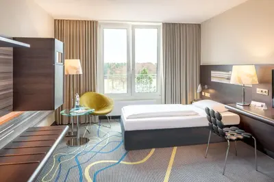 Ein Bett oder Betten in einem Zimmer der Unterkunft Dorint Am Nürburgring Hocheifel