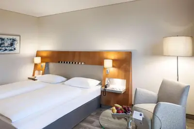Ein Bett oder Betten in einem Zimmer der Unterkunft Dorint Am Nürburgring Hocheifel