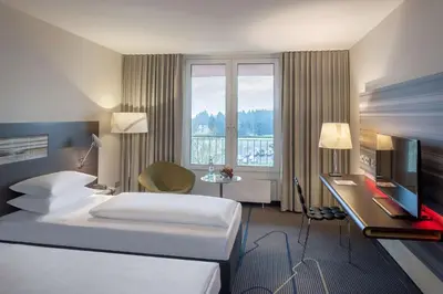 Ein Bett oder Betten in einem Zimmer der Unterkunft Dorint Am Nürburgring Hocheifel