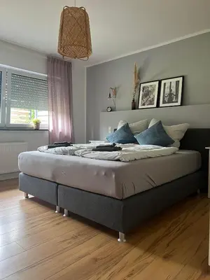 Ein Bett oder Betten in einem Zimmer der Unterkunft Moderne familienfreundliche Wohnung am Waldrand von Prüm mit Terrasse