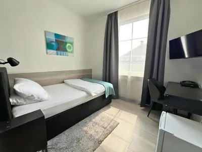 Ein Bett oder Betten in einem Zimmer der Unterkunft City Hotel Neuwied